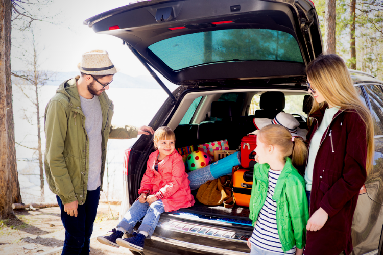 Photo of a family on a road trip. Top Ten Driving Safety Tips.