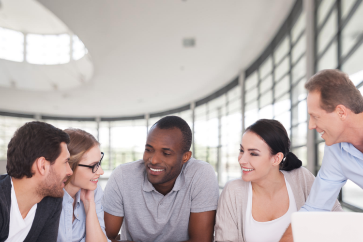 Photo of a group of co-workers in a meeting.