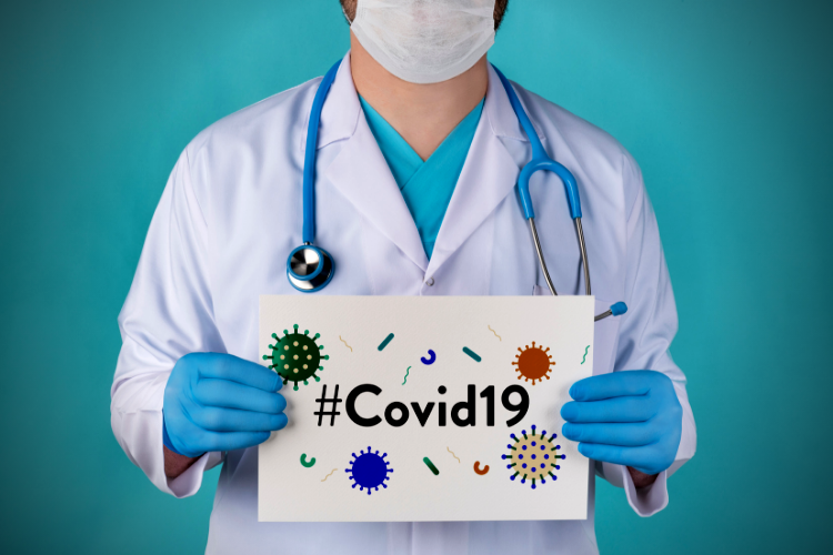 doctor holding a #covid19 sign