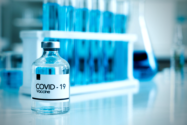 Photo of covid-19 vaccine in glass bottle